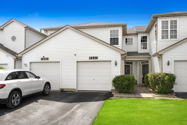 16526 S Nottingham Ct, Lockport, IL 60441 - view of property featuring an attached garage, driveway, and a front lawn