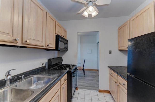 kitchen with black appliances, light brown cabinets, a sink, and a ceiling fan