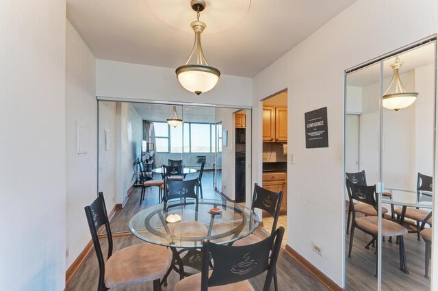 dining room featuring wood finished floors and baseboards