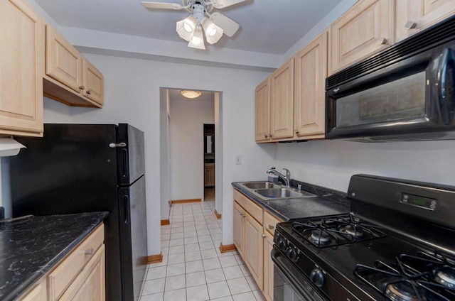 kitchen with black appliances, a sink, light brown cabinetry, light tile patterned floors, and a ceiling fan