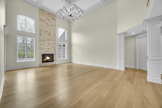 1212 Georgias Way, New Lenox, IL 60451 - unfurnished living room with light wood finished floors, a high ceiling, plenty of natural light, a chandelier, and stairway