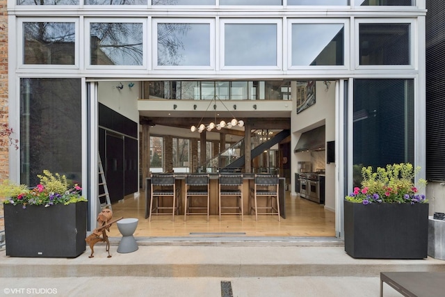 1804 N Leavitt St, Chicago, IL 60647 - kitchen with modern cabinets, a high ceiling, dark cabinetry, a sink, and light wood-style floors