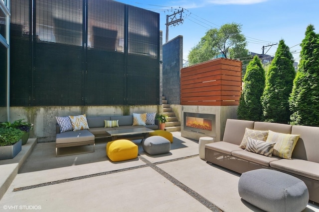 view of patio featuring an outdoor living space with a fireplace