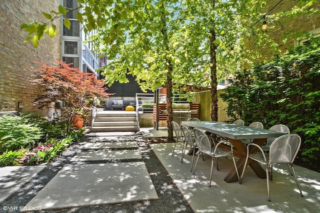 view of patio / terrace with a deck and outdoor dining space