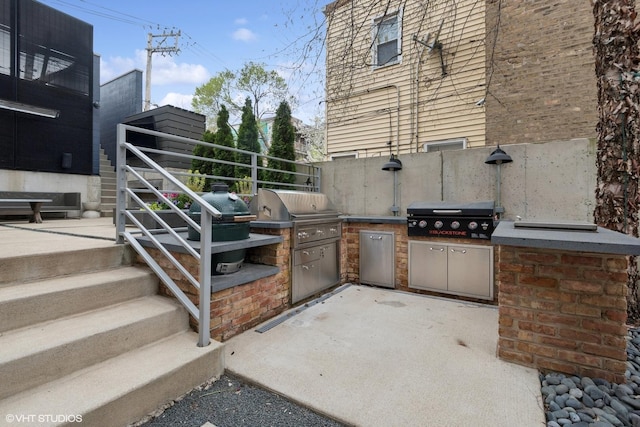 view of patio / terrace with exterior kitchen and a grill