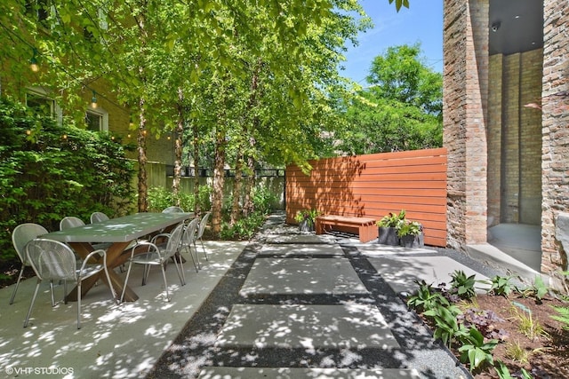 view of patio with fence and outdoor dining space