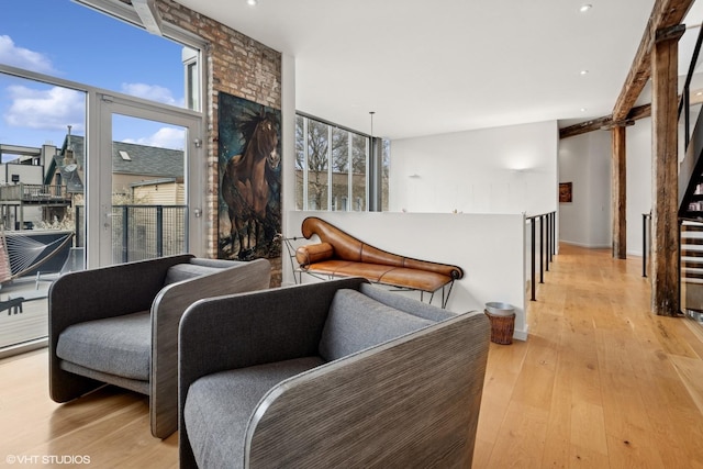 sitting room featuring light wood-style flooring, a wealth of natural light, and recessed lighting