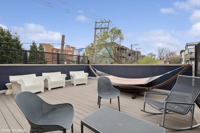 wooden terrace with an outdoor hangout area
