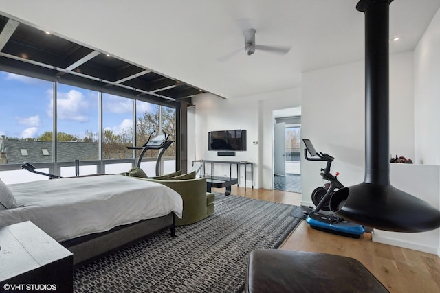 bedroom featuring beam ceiling, recessed lighting, coffered ceiling, and wood finished floors