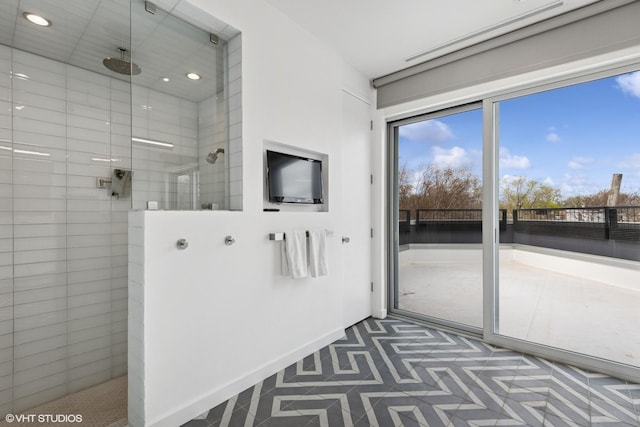 full bath featuring baseboards, recessed lighting, plenty of natural light, and a walk in shower
