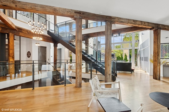 1804 N Leavitt St, Chicago, IL 60647 - hallway featuring wood finished floors, healthy amount of natural light, brick wall, and a high ceiling