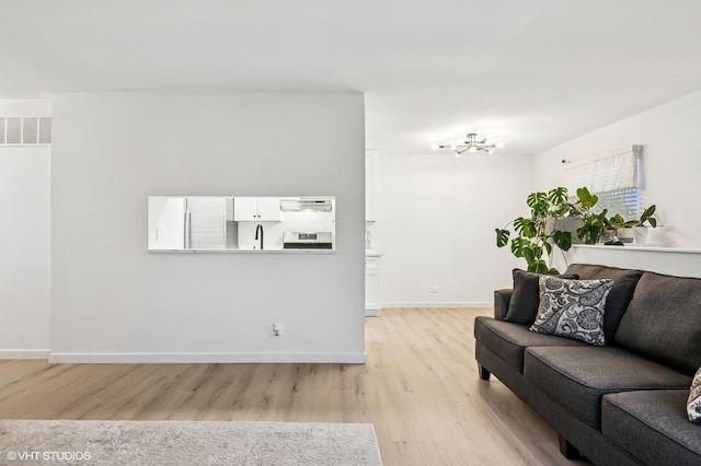 1387 Woodcutter Ln Unit D, Wheaton, IL 60189 - living area with baseboards, visible vents, and light wood-type flooring