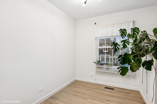 1387 Woodcutter Ln Unit D, Wheaton, IL 60189 - unfurnished room with baseboards, visible vents, and wood finished floors