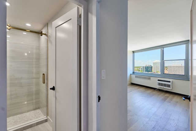 555 W Cornelia Ave Unit 1906, Chicago, IL 60657 - bathroom featuring radiator, wood finished floors, a shower stall, recessed lighting, and baseboards