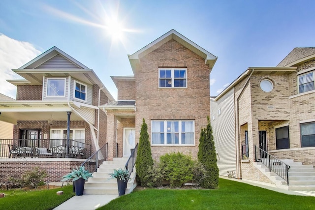 view of front of property with brick siding and stairs