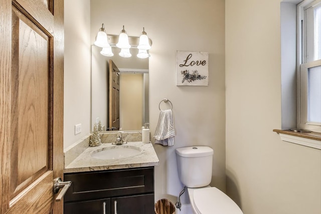 half bathroom featuring toilet and vanity