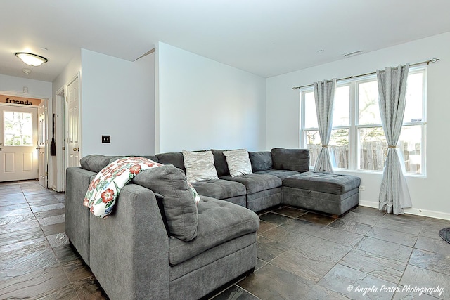 613 W Pheasant Ct, Round Lake Beach, IL 60073 - living room featuring stone tile floors and baseboards