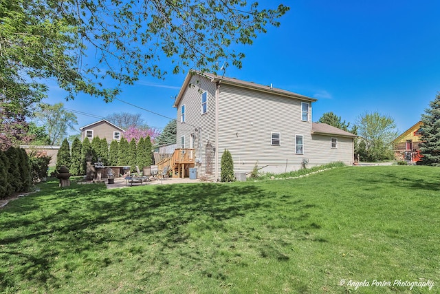 613 W Pheasant Ct, Round Lake Beach, IL 60073 - rear view of house with a fire pit, a lawn, and a patio