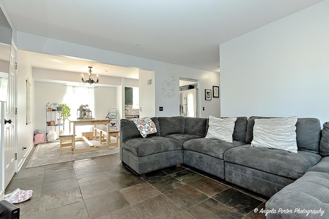 613 W Pheasant Ct, Round Lake Beach, IL 60073 - living area with a chandelier and stone tile floors