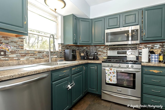 613 W Pheasant Ct, Round Lake Beach, IL 60073 - kitchen featuring stainless steel appliances, a sink, decorative backsplash, and light countertops