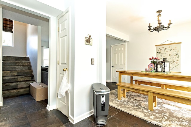 613 W Pheasant Ct, Round Lake Beach, IL 60073 - hall with stairs, a chandelier, and baseboards