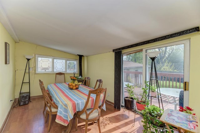1431 N Hillside Ave, Berkeley, IL 60163 - dining space with wood finished floors, baseboards, lofted ceiling, and a wood stove