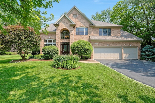 28W624 Berkshire Rd, West Chicago, IL 60185 - traditional home featuring asphalt driveway, a front yard, a garage, and brick siding
