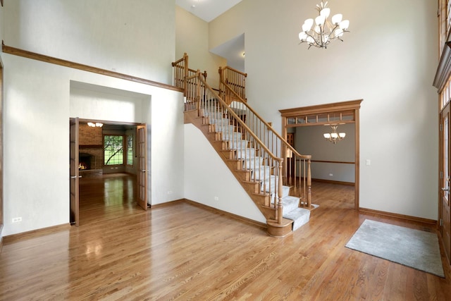 28W624 Berkshire Rd, West Chicago, IL 60185 - foyer with a chandelier, a towering ceiling, stairway, wood finished floors, and baseboards