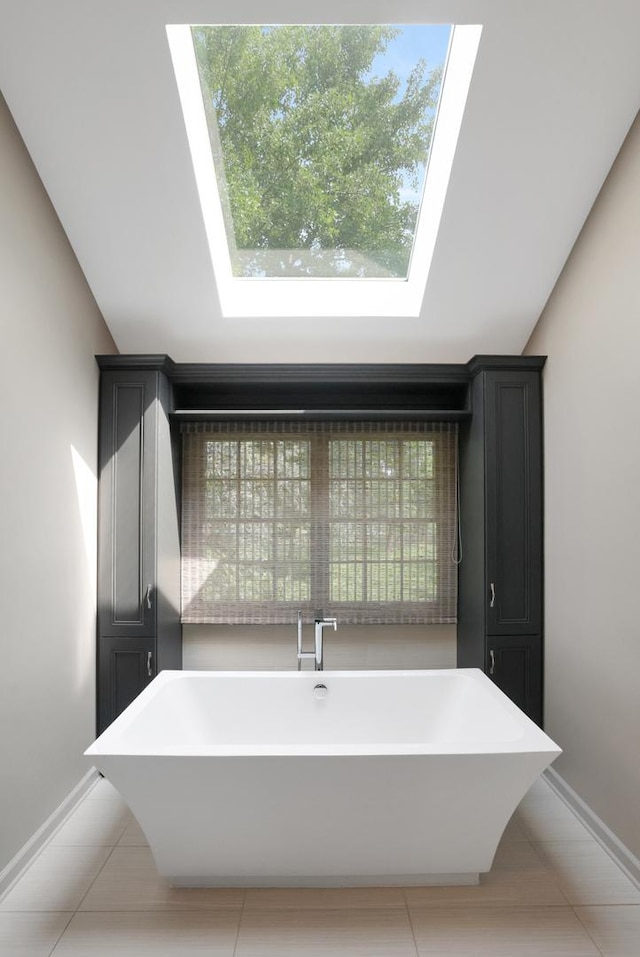 28W624 Berkshire Rd, West Chicago, IL 60185 - full bath with a freestanding tub, a skylight, tile patterned floors, and baseboards