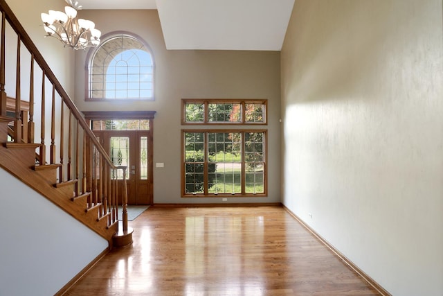 28W624 Berkshire Rd, West Chicago, IL 60185 - entrance foyer with stairway, a chandelier, wood finished floors, a towering ceiling, and baseboards