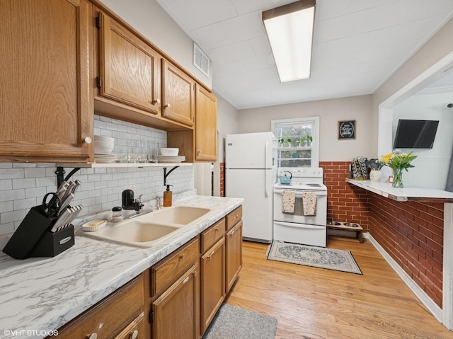 1345 Winaki Trl, Algonquin, IL 60102 - kitchen featuring white appliances, a sink, light countertops, light wood-style flooring, and decorative backsplash
