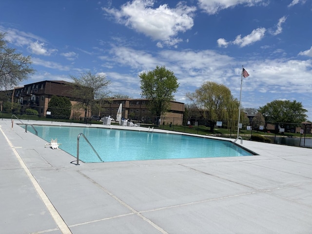 community pool featuring fence and a patio
