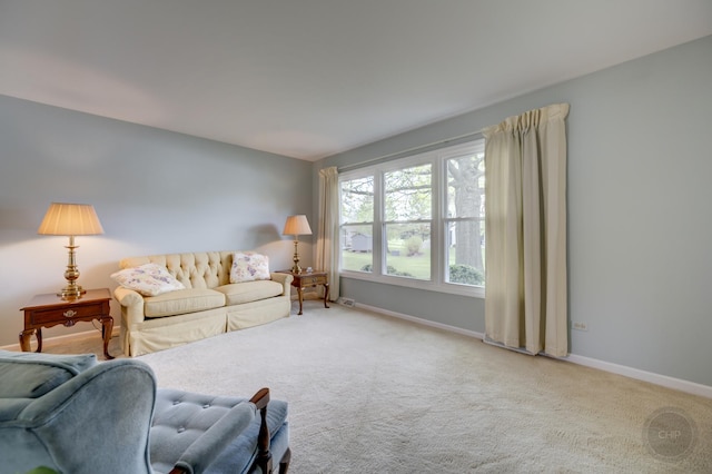 living room with baseboards and carpet