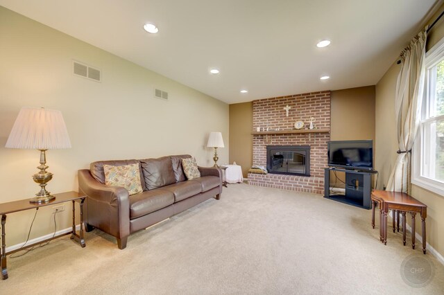 living room featuring carpet floors, a brick fireplace, plenty of natural light, and recessed lighting