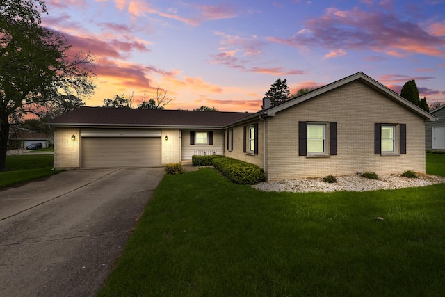 610 Kensington Dr, Mchenry, IL 60050 - ranch-style house with brick siding, a garage, a front yard, and driveway