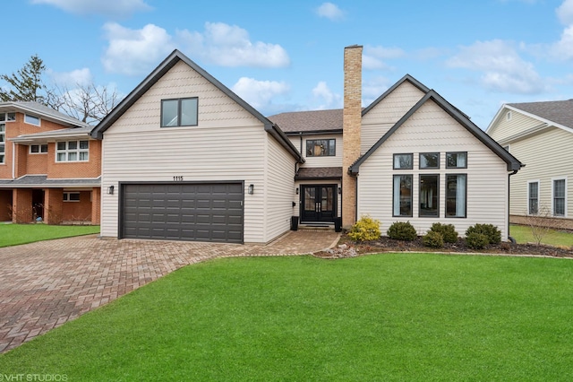 1115 Hunter Rd, Glenview, IL 60025 - view of front of property featuring decorative driveway, french doors, a front lawn, and a chimney