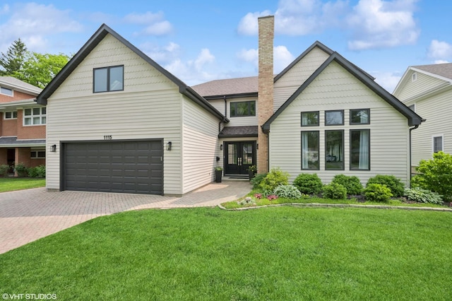 1115 Hunter Rd, Glenview, IL 60025 - view of front of property featuring french doors, a garage, decorative driveway, a front lawn, and a chimney