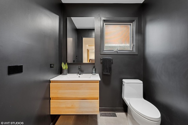 1115 Hunter Rd, Glenview, IL 60025 - half bathroom featuring toilet, vanity, and baseboards