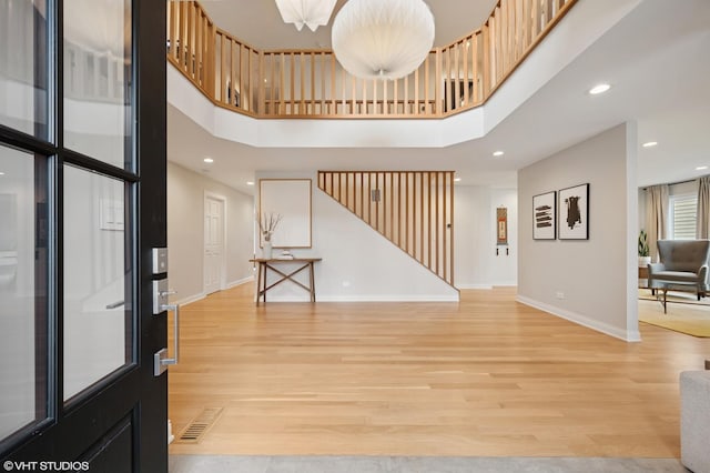 1115 Hunter Rd, Glenview, IL 60025 - entryway featuring baseboards, a towering ceiling, light wood-style flooring, recessed lighting, and stairway