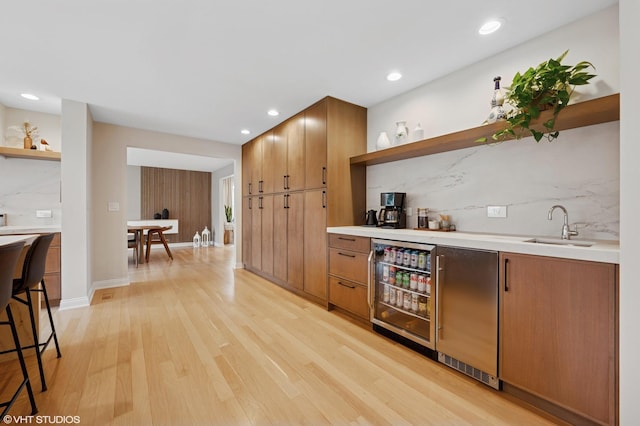 1115 Hunter Rd, Glenview, IL 60025 - indoor wet bar featuring beverage cooler, decorative backsplash, light wood-style flooring, and recessed lighting