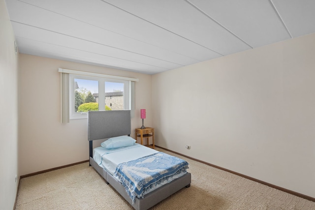 carpeted bedroom featuring baseboards