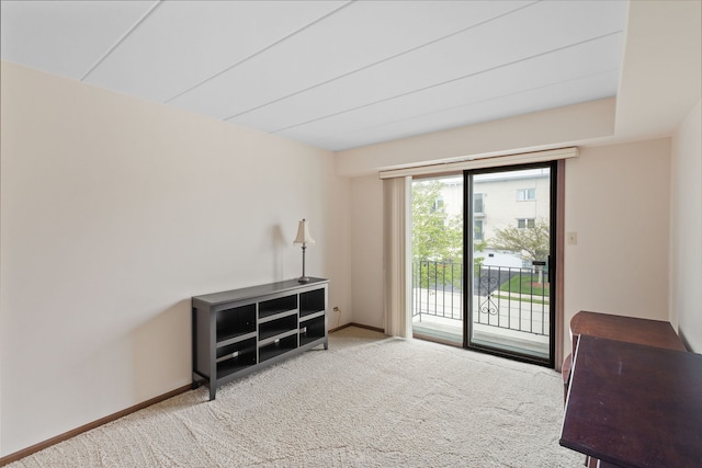 living area featuring carpet and baseboards
