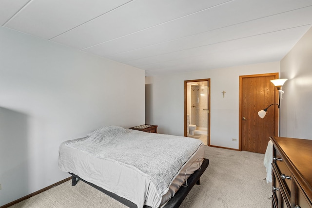 bedroom featuring light colored carpet, connected bathroom, and baseboards