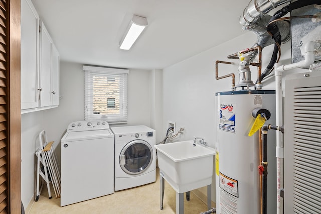 clothes washing area with cabinet space, water heater, independent washer and dryer, and heating unit