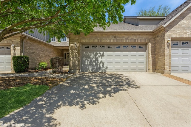 165 Mclaren Dr N, Sycamore, IL 60178 - traditional-style home featuring brick siding, driveway, a garage, and roof with shingles
