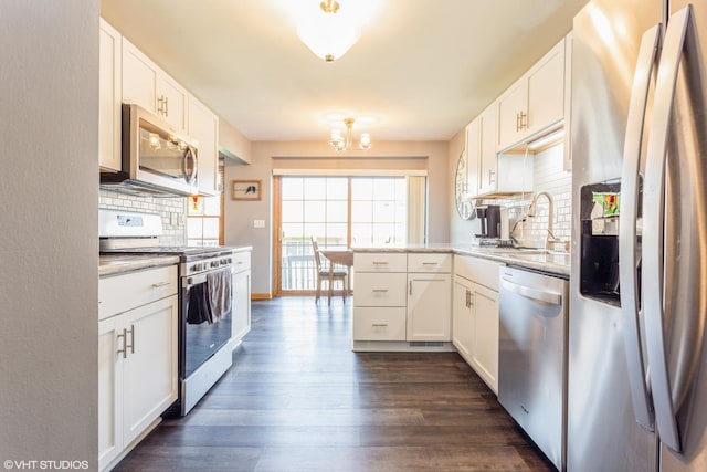 165 Mclaren Dr N, Sycamore, IL 60178 - kitchen featuring stainless steel appliances, backsplash, dark wood-style flooring, a chandelier, and white cabinetry