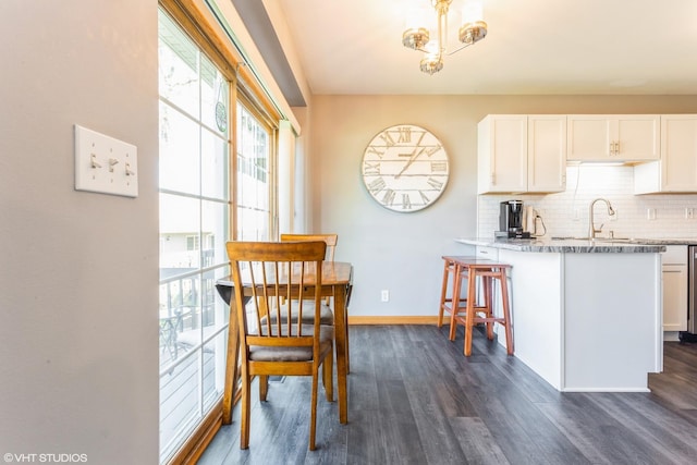 165 Mclaren Dr N, Sycamore, IL 60178 - kitchen with dark wood-style flooring, white cabinets, backsplash, and baseboards