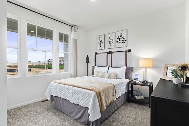 carpeted bedroom with baseboards
