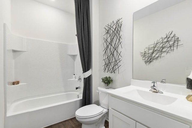 bathroom with toilet, vanity, wood finished floors, and shower / tub combination