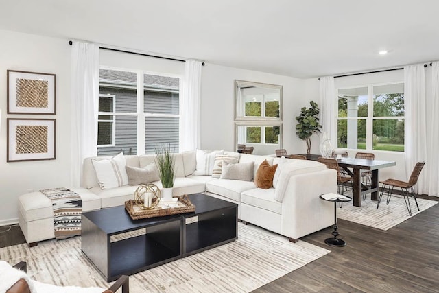 living area featuring wood finished floors, plenty of natural light, recessed lighting, and baseboards